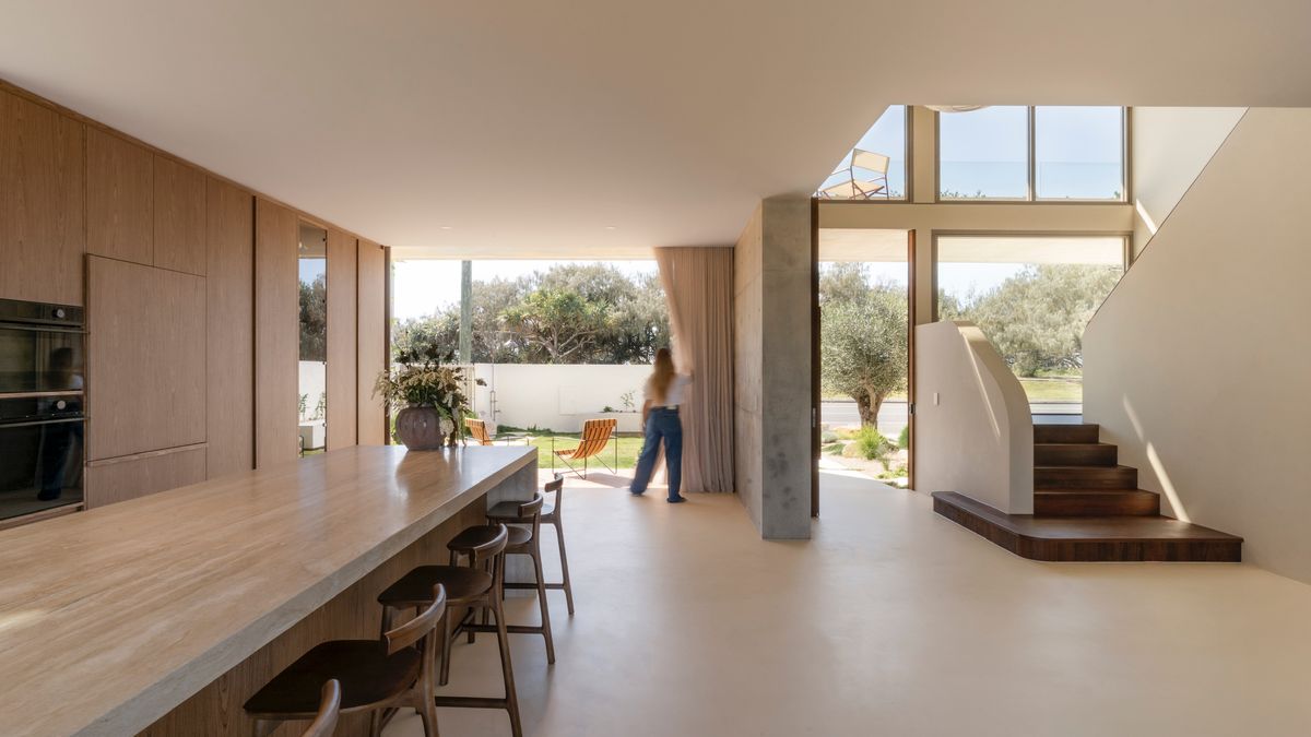 Open-plan kitchen and staircase — House on Pacific