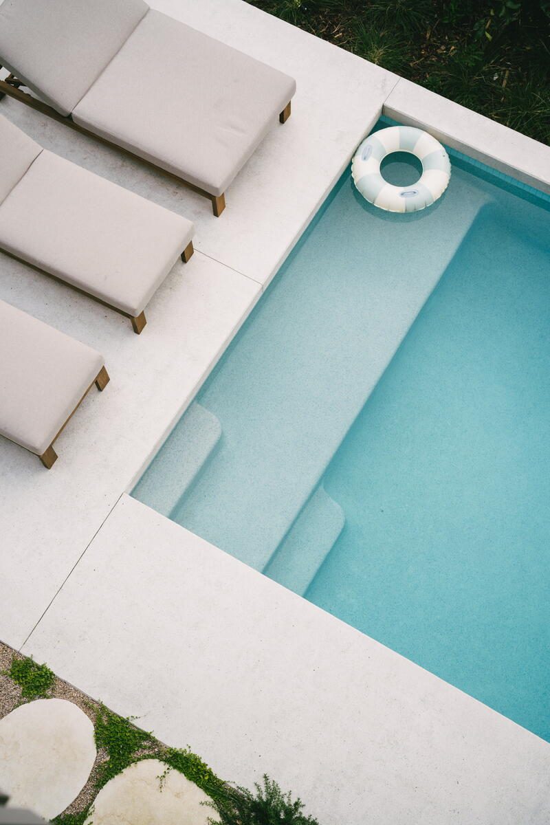 Aerial view of concrete pool with sun loungers