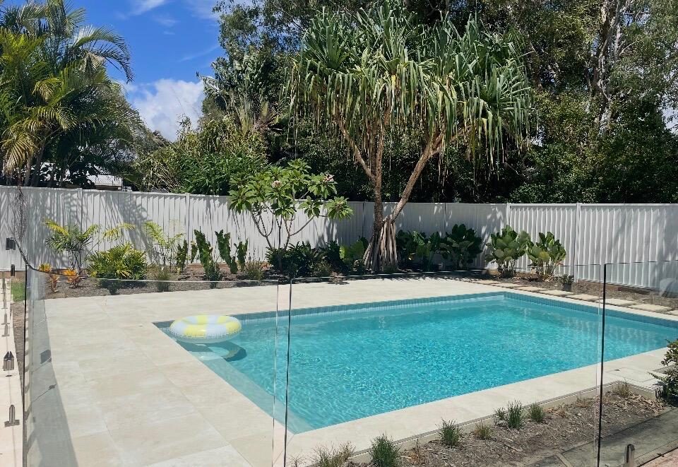Concrete pool with tropical landscaping